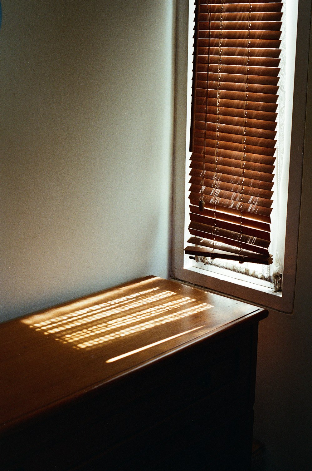 brown window blinds on window