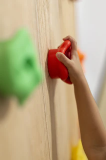 person holding red heart shaped ornament
