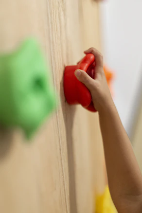 person holding red heart shaped ornament