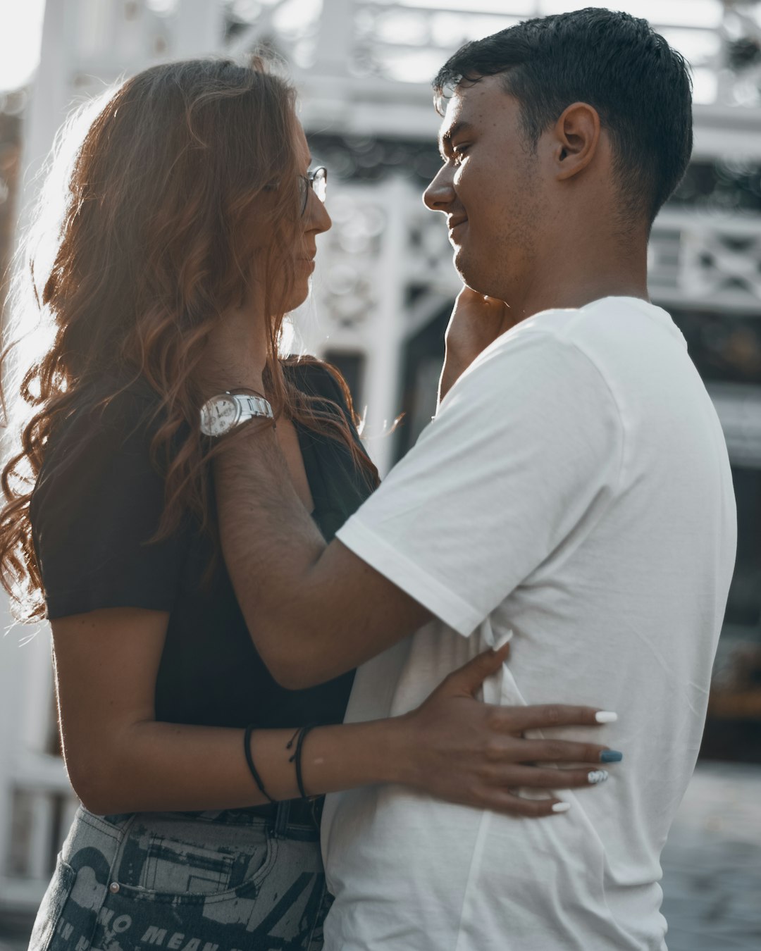 man in white t-shirt hugging woman in black t-shirt