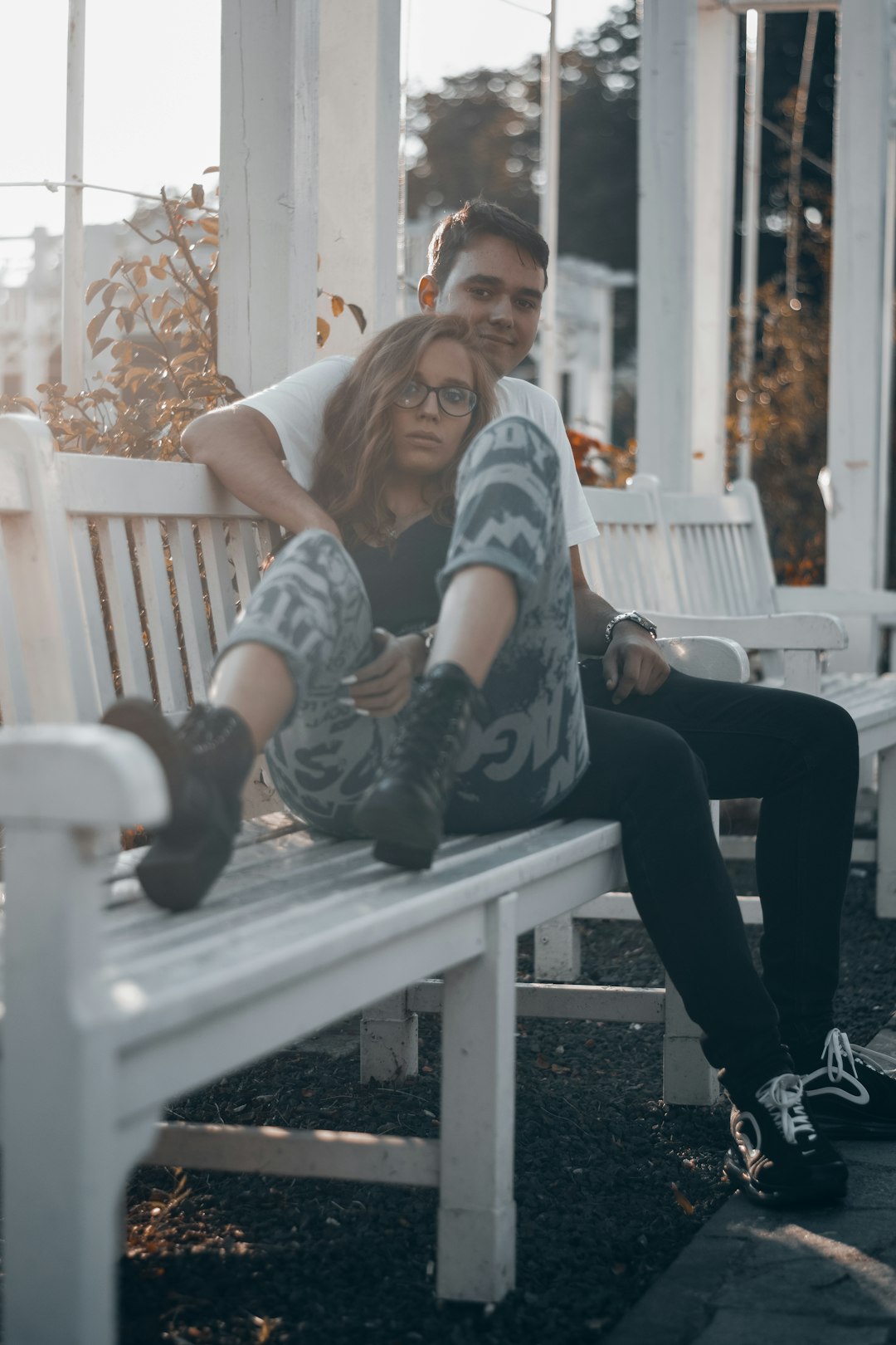 man and woman sitting on bench