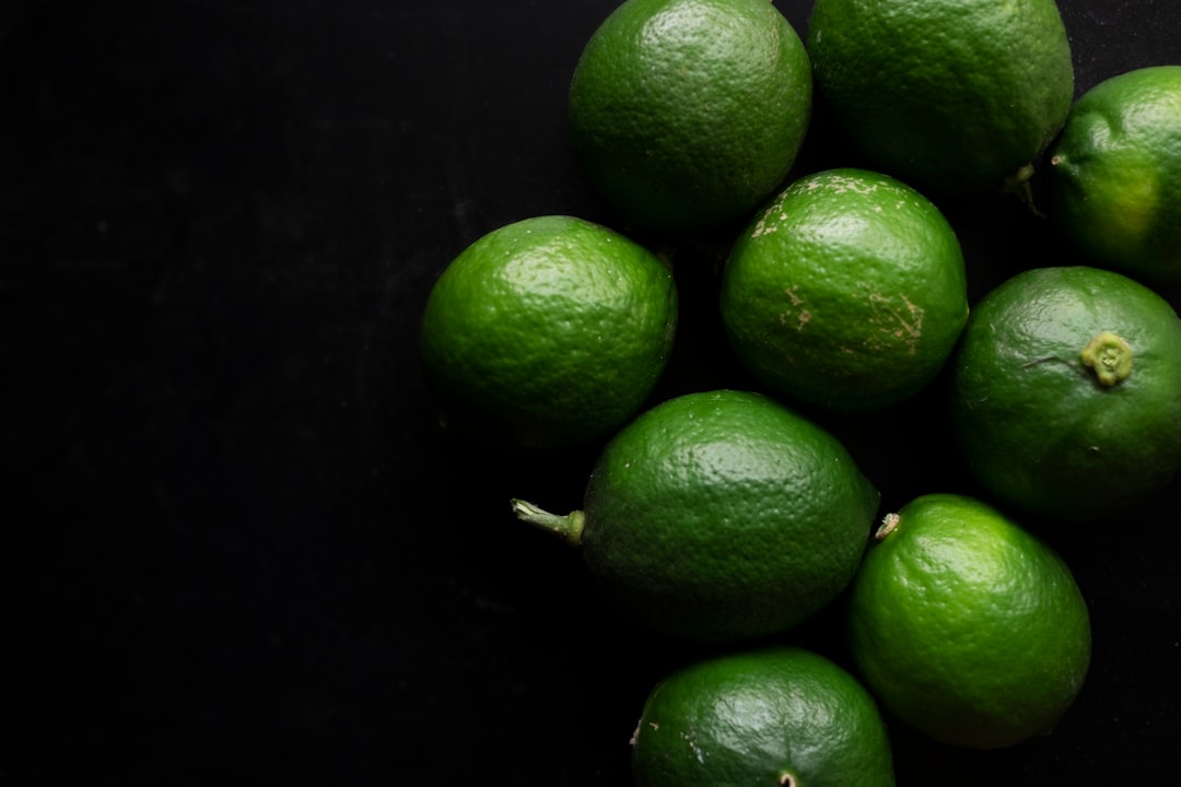 green lime fruit on black surface