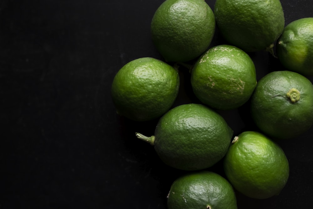 green lime fruit on black surface