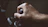 Close-up of a hand holding a sturdy electrical switch with a dark tech-inspired background.