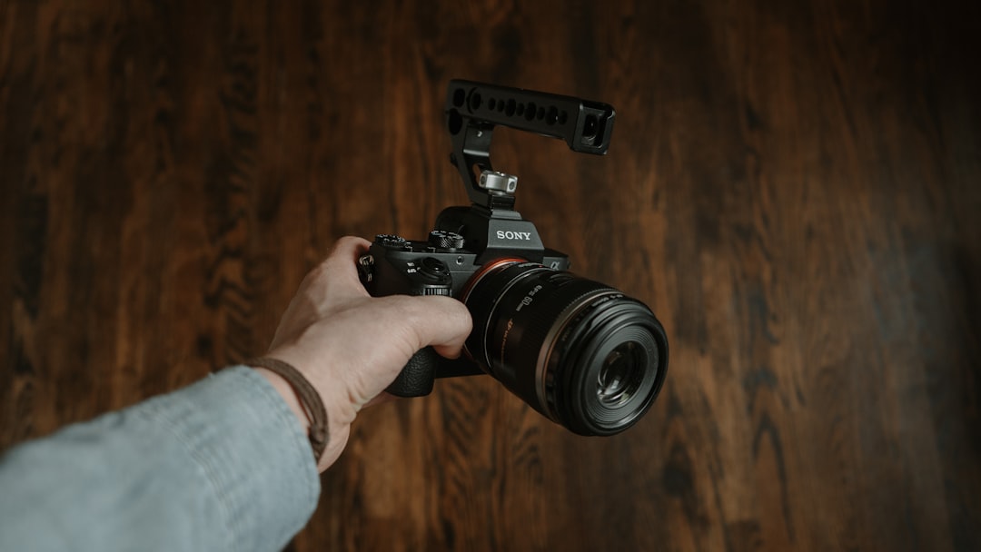 person holding black nikon dslr camera