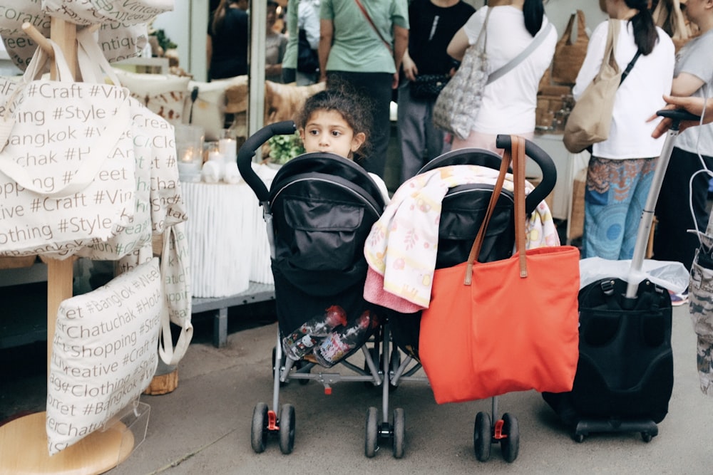 baby in stroller near people standing