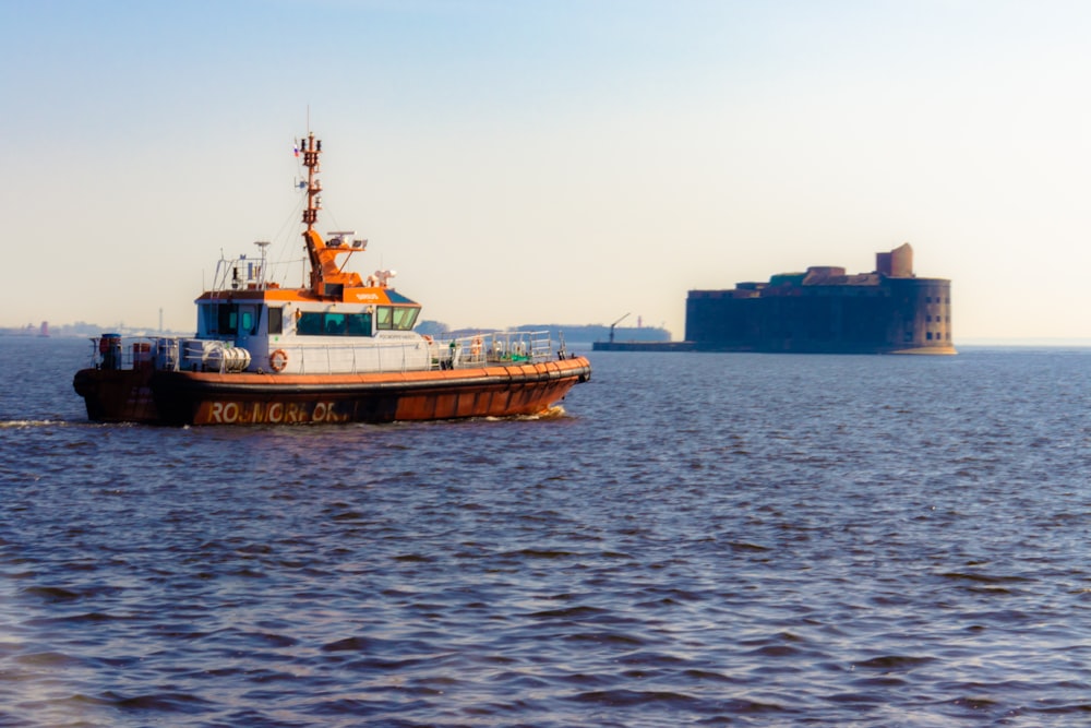 red and white ship on sea during daytime