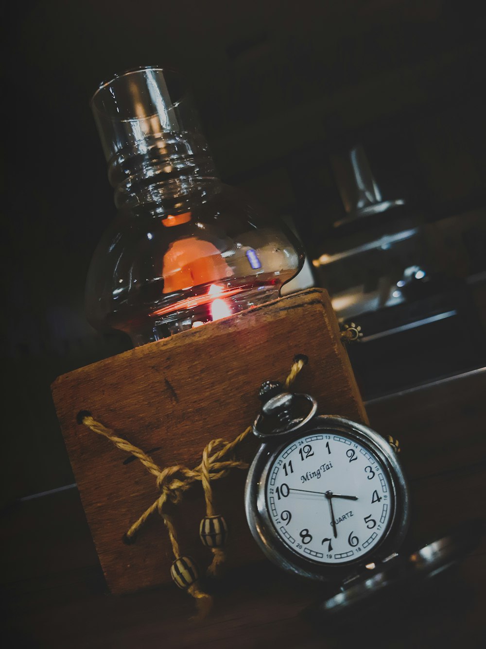 black and white analog alarm clock at 10 00