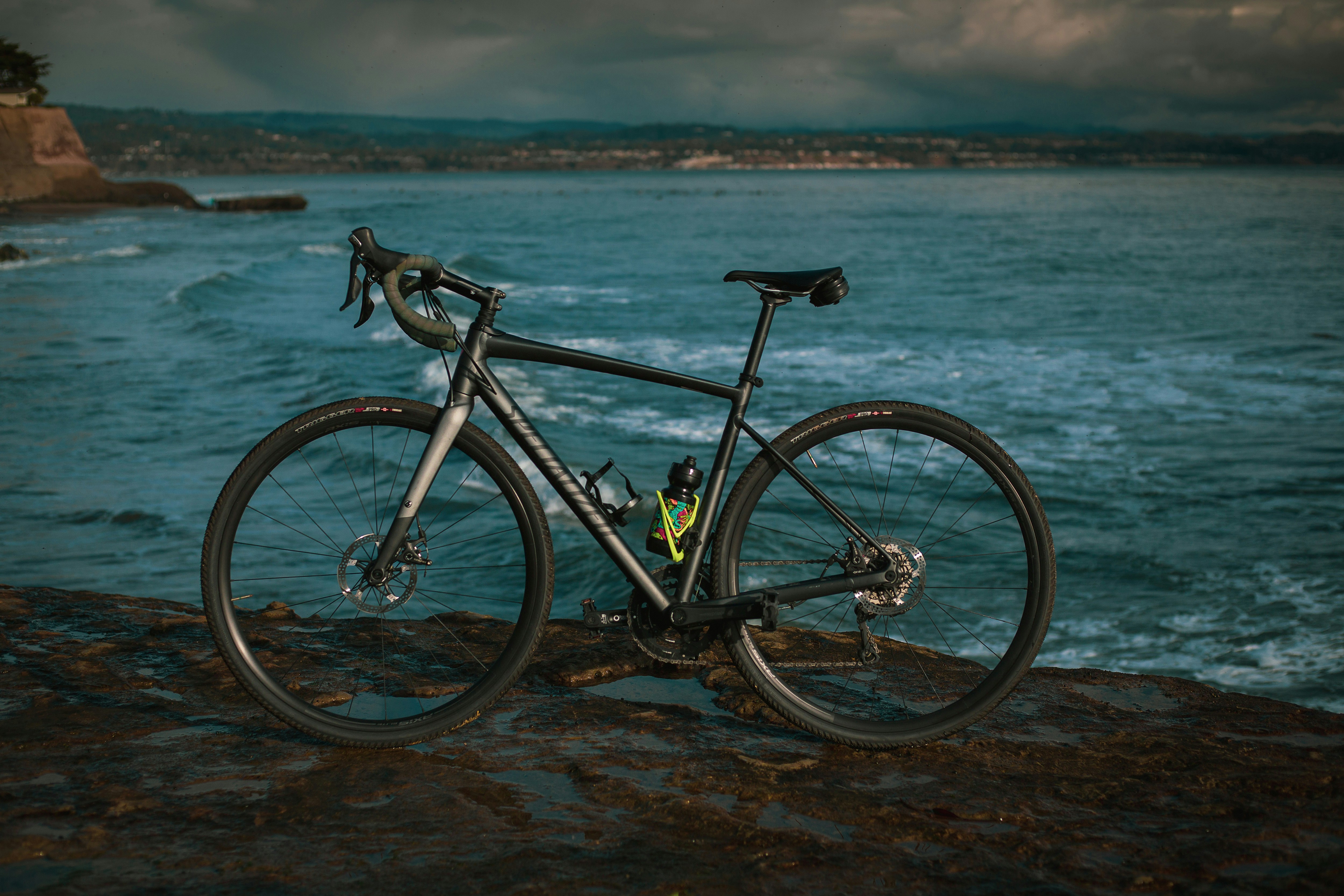 black and white mountain bike on seashore during daytime