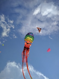 green yellow and red hot air balloon under blue sky