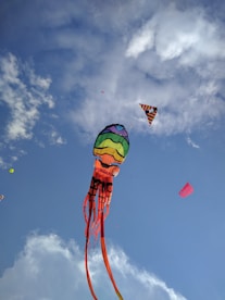 green yellow and red hot air balloon under blue sky
