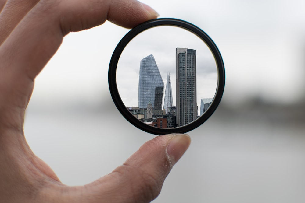 person holding round black frame