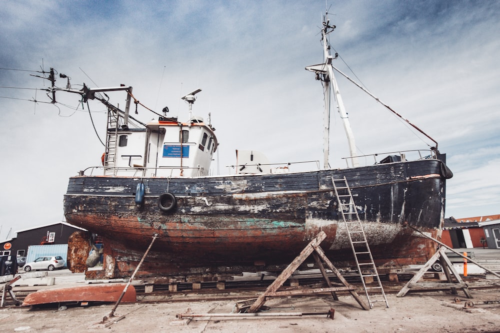 brown and white ship on brown sand during daytime