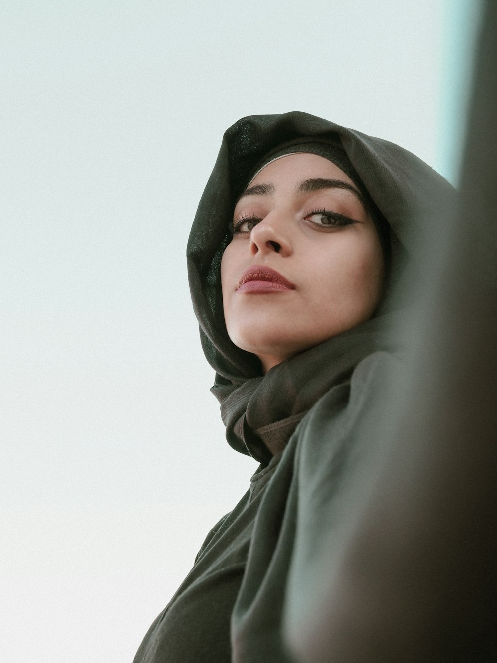 woman in gray hijab taking selfie