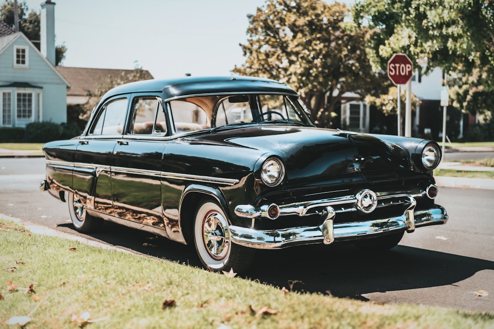 blue classic car on green grass field during daytime