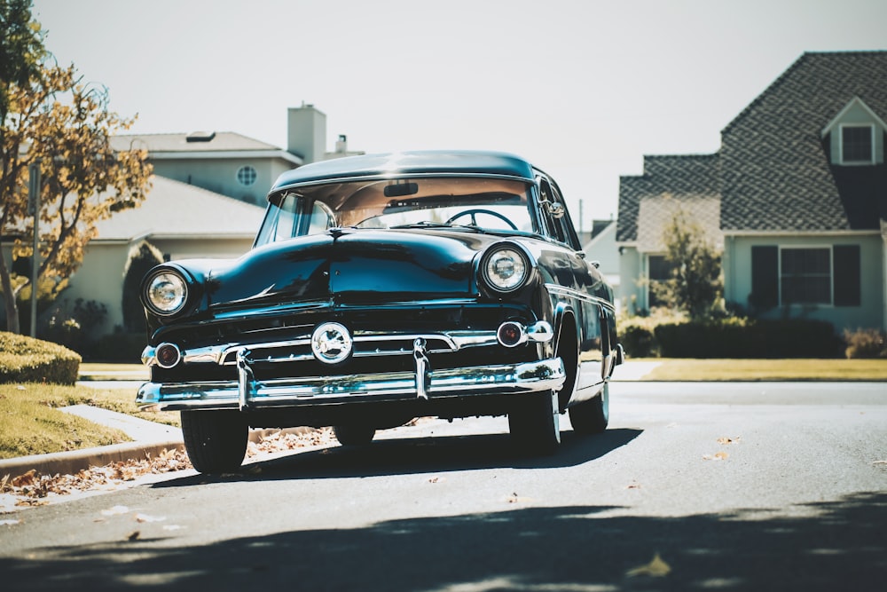 blue classic car parked on parking lot during daytime