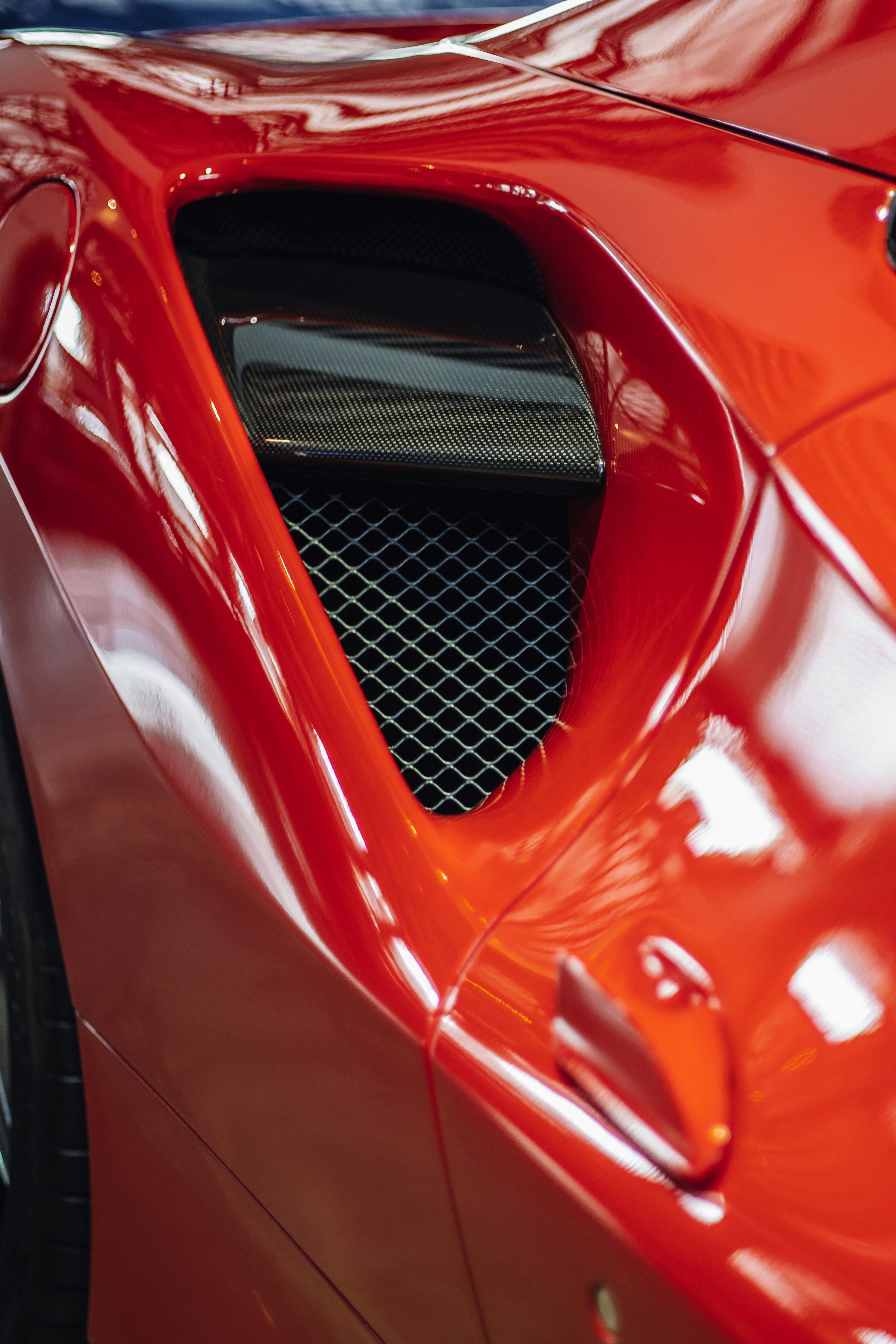 red car with white metal grille