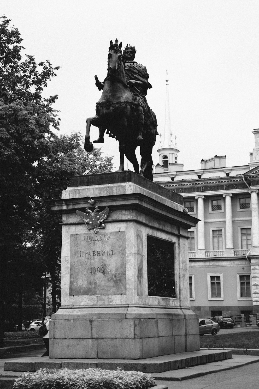 grayscale photo of man riding horse statue