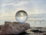 clear glass ball on brown rock