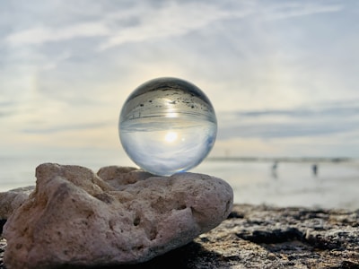 clear glass ball on brown rock