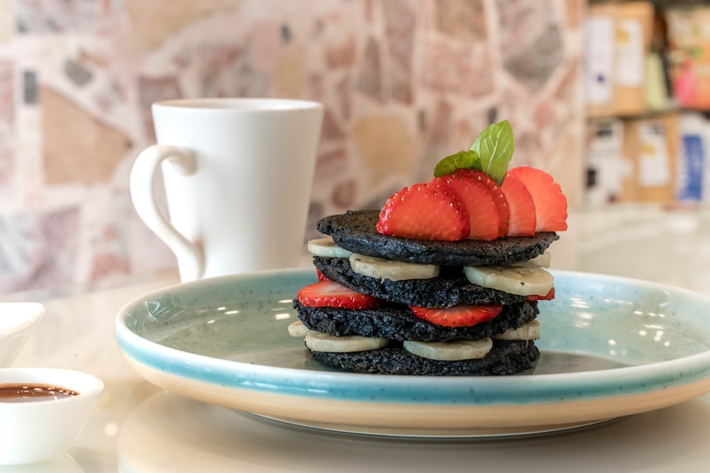 strawberry and blueberry on white ceramic plate