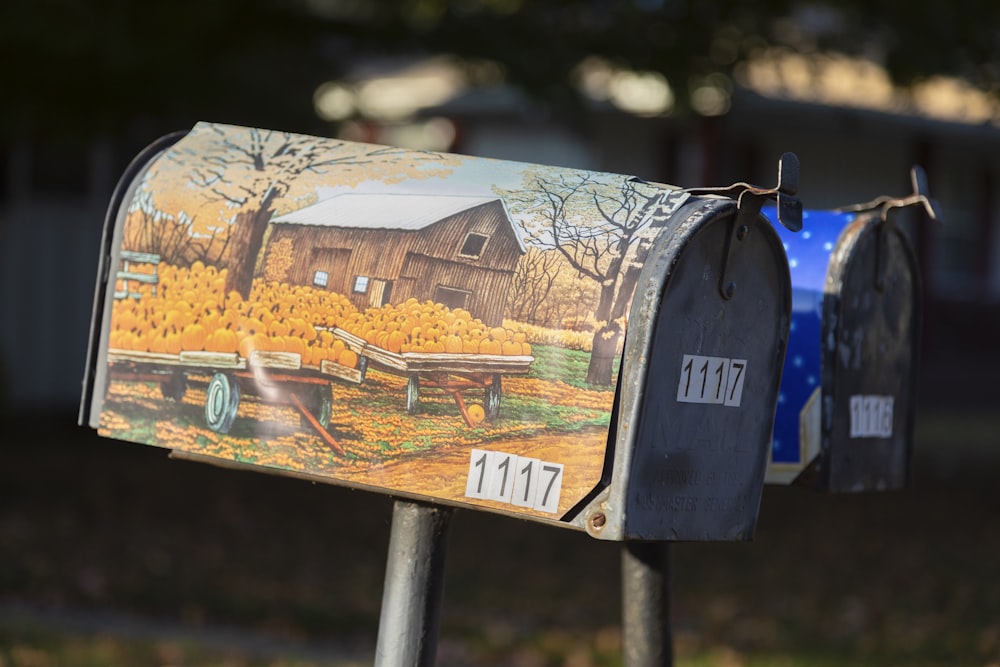 brown and white mail box on brown wooden fence during daytime