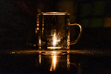 Floating, frosted glass effect display of a custom printed mug with soft glowing highlights.