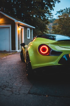 green ferrari 458 italia parked near white house