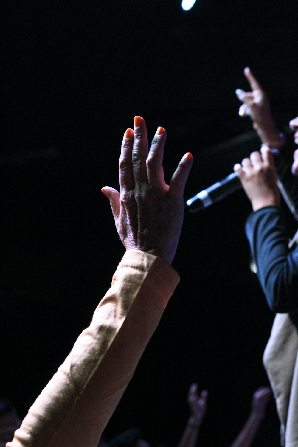 person in gray long sleeve shirt with orange manicure