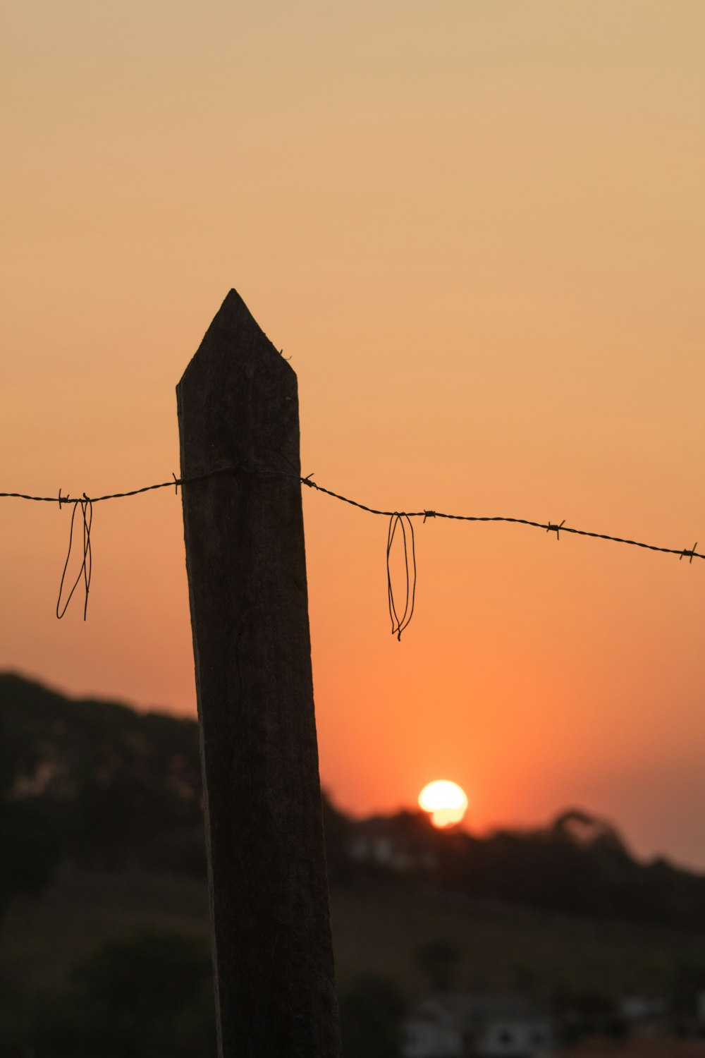 brown wooden post during sunset