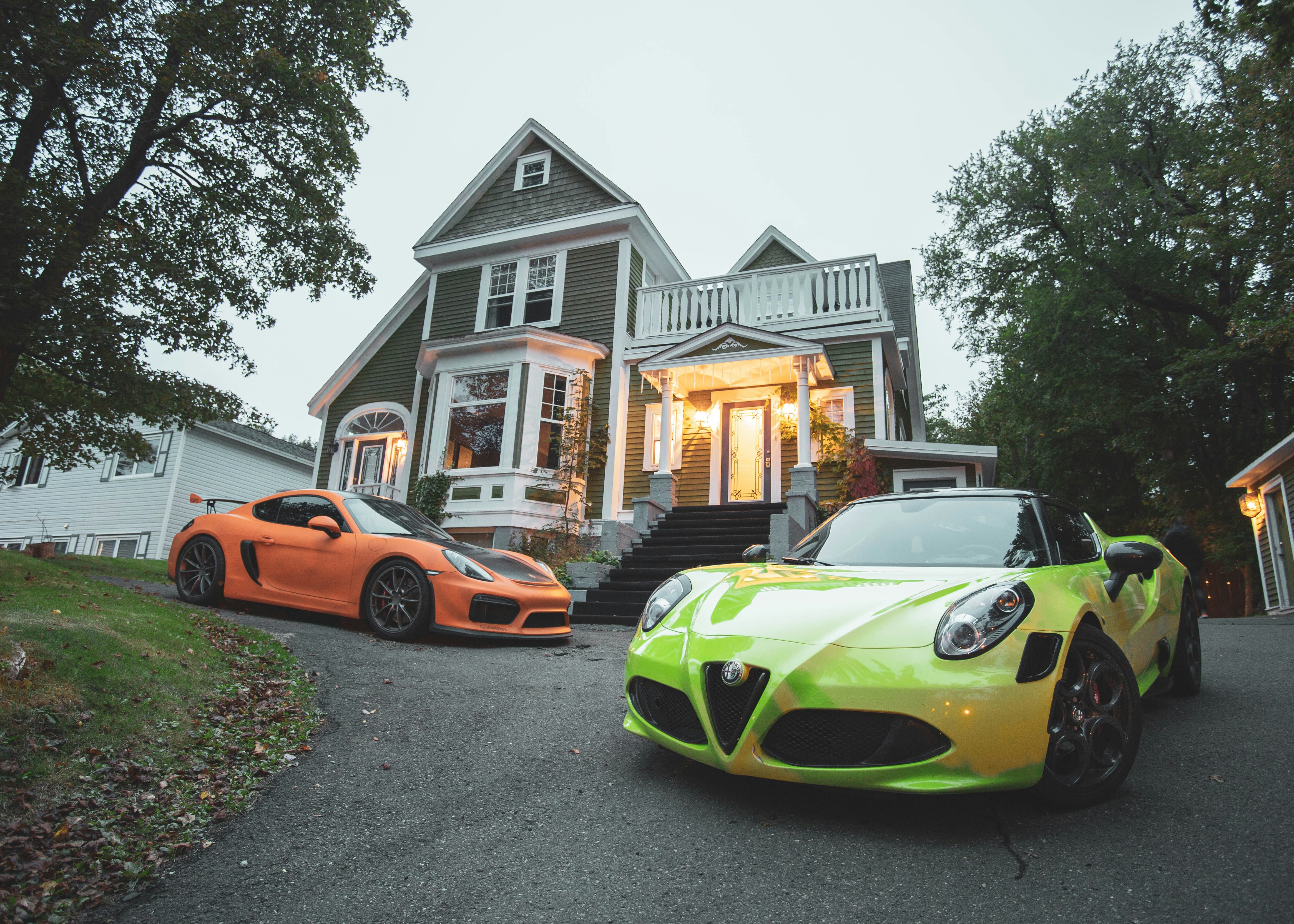 yellow lamborghini aventador parked near white and gray house during daytime