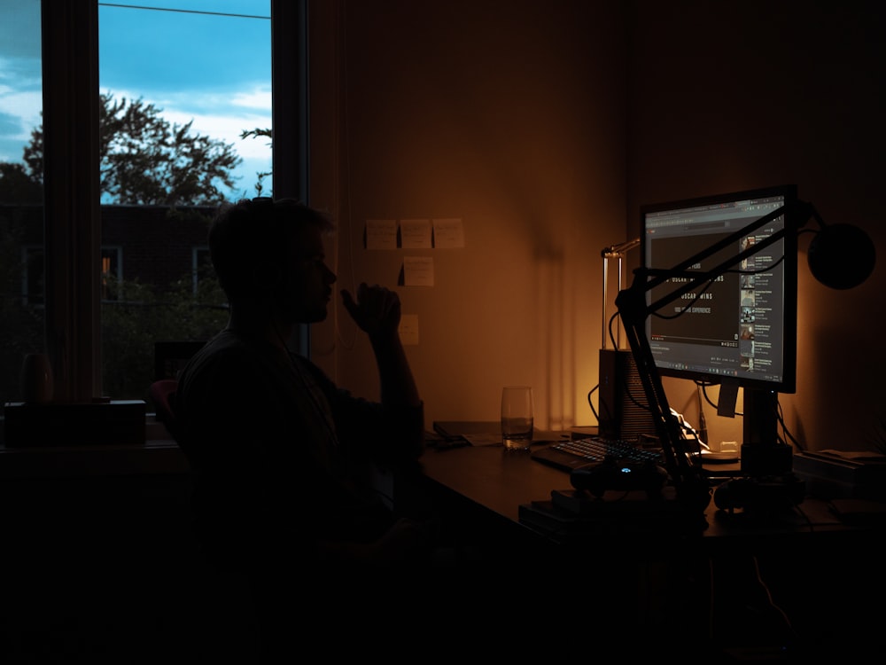 silhouette of person sitting on chair