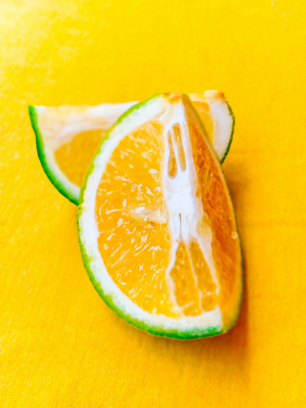 sliced lemon on yellow surface