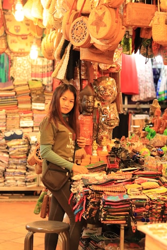 woman in brown long sleeve shirt standing beside assorted plastic packs