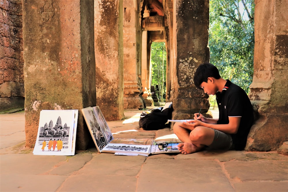 boy in black t-shirt sitting on floor