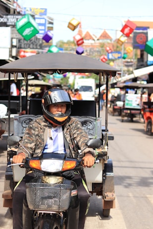 A courier on a motorcycle weaving through the colorful streets of Cusco.