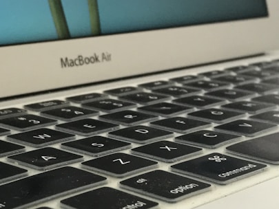 A technician repairing a MacBook keyboard.