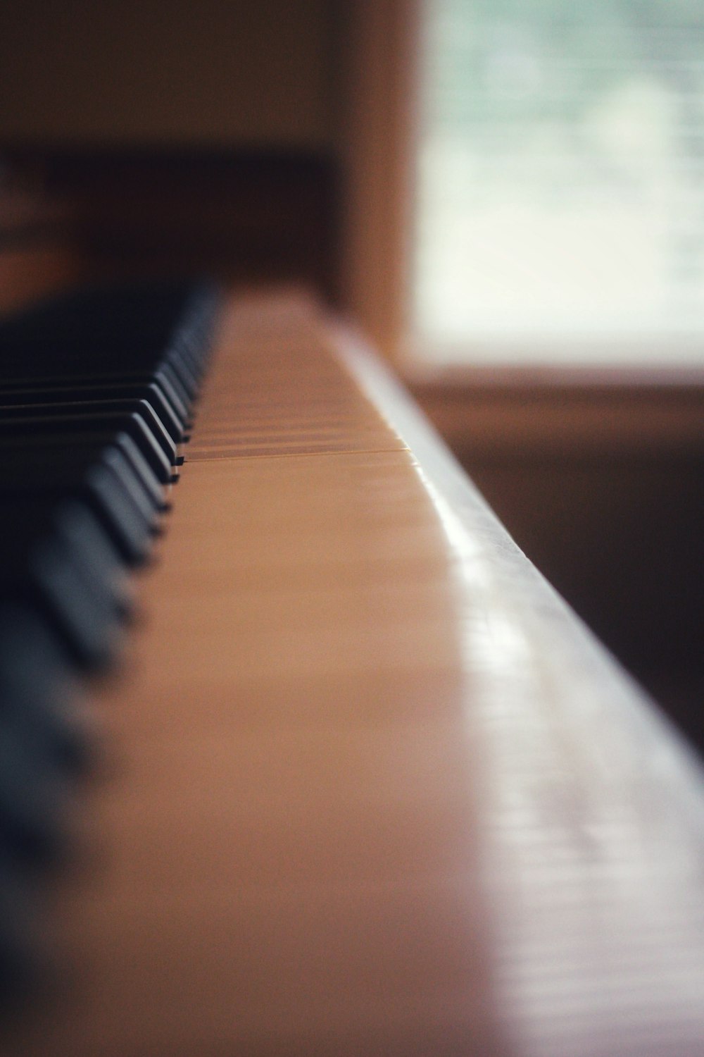 brown wooden piano keys in close up photography