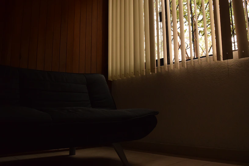 Modern living room with automated curtains partially drawn, showcasing smart home ambiance.