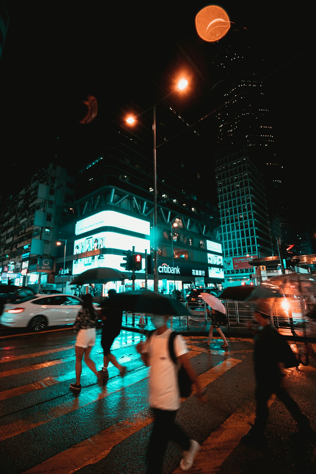 people walking on pedestrian lane during night time