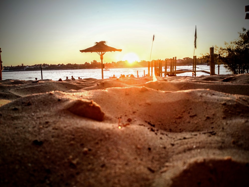 brown umbrella on beach during daytime