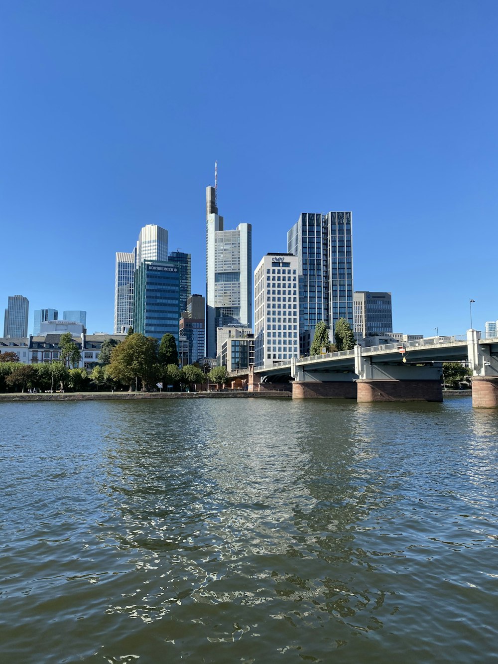 white and brown boat on water near city buildings during daytime