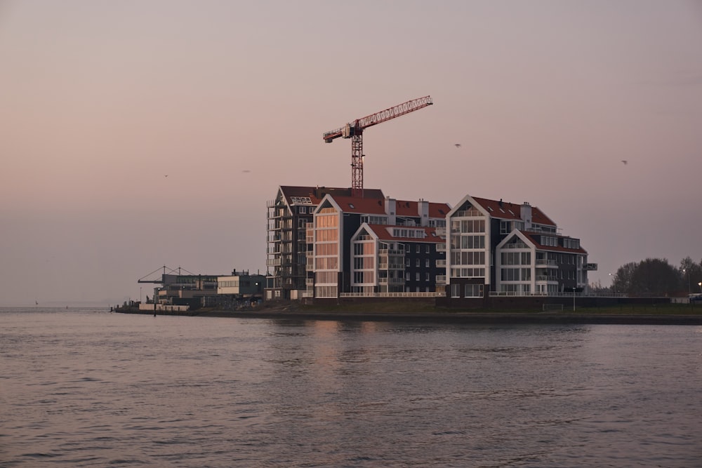 brown and white concrete building beside body of water during daytime