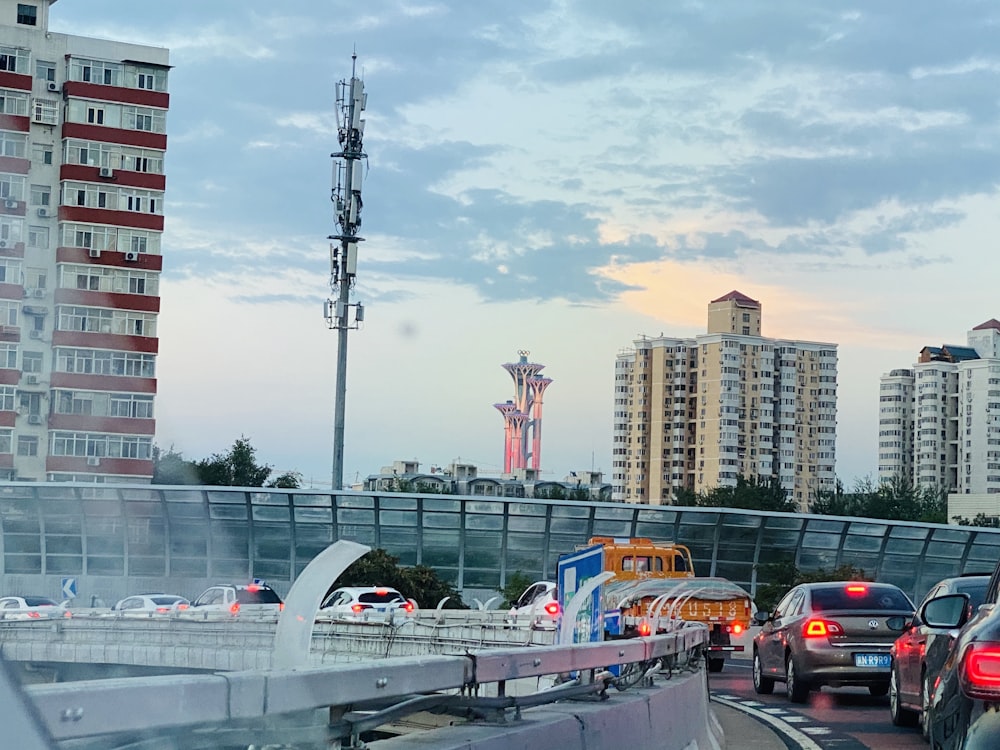 cars on road near city buildings during daytime