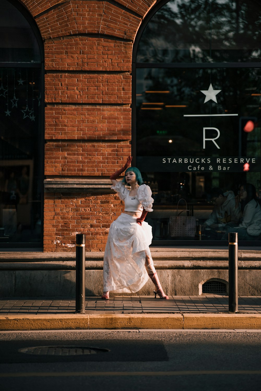 woman in white dress standing on brown wooden bench during daytime