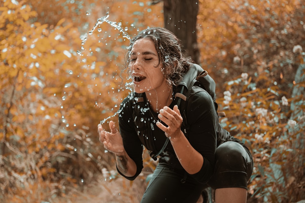 woman in black leather jacket blowing bubbles