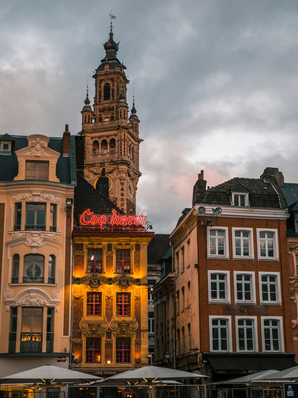 brown concrete building under cloudy sky during daytime