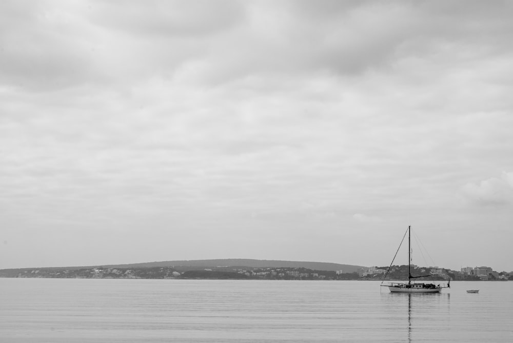 grayscale photo of sailboat on sea