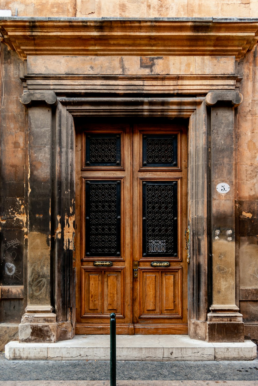 brown wooden door on gray concrete building