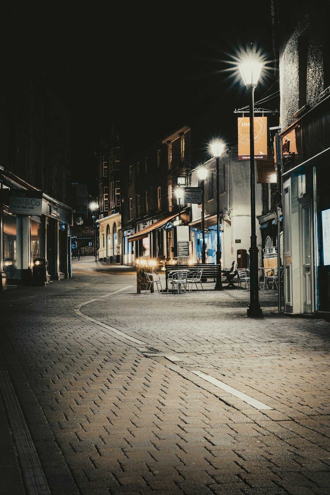 people walking on sidewalk during night time